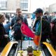 MIT AUV Lab's Paul Robinette talks to a couple with a baby about a yellow AUV on display