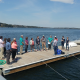 A group of scientists and volunteeres gathered on a dock for Shell Day last year