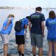 A group of citizen scientists perform bucket sampling on a dock in Boston Harbor.