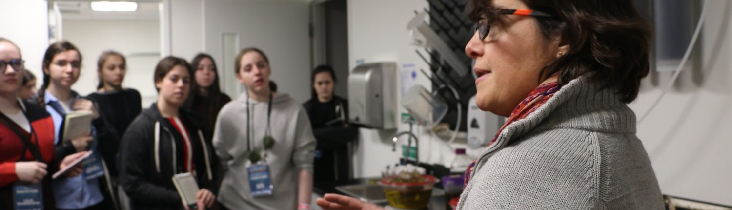 Carolina Bastidas, MIT Sea Grant Research Scientist, speaks to a group of female students in the lab.