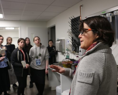 Carolina Bastidas, MIT Sea Grant Research Scientist, speaks to a group of female students in the lab.