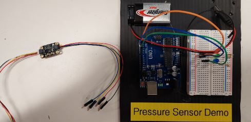 LED circuit on a solderless breadboard, mounted next to an Arduino