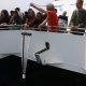 Keith Ellenbogen pulls a plankton tow in from the ocean onto the Boston whale watch boat